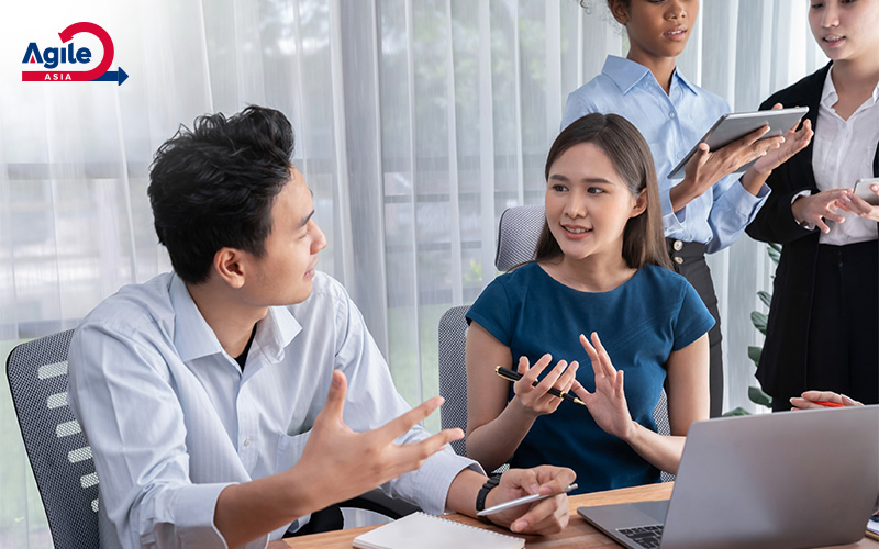 Agile Asia team discussing project strategies in a meeting.